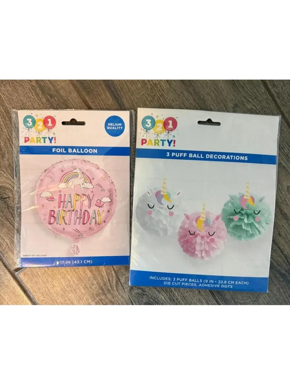 321 Party Foil Unicorn Balloon and 3 Puff Ball Decorations that are unicorn